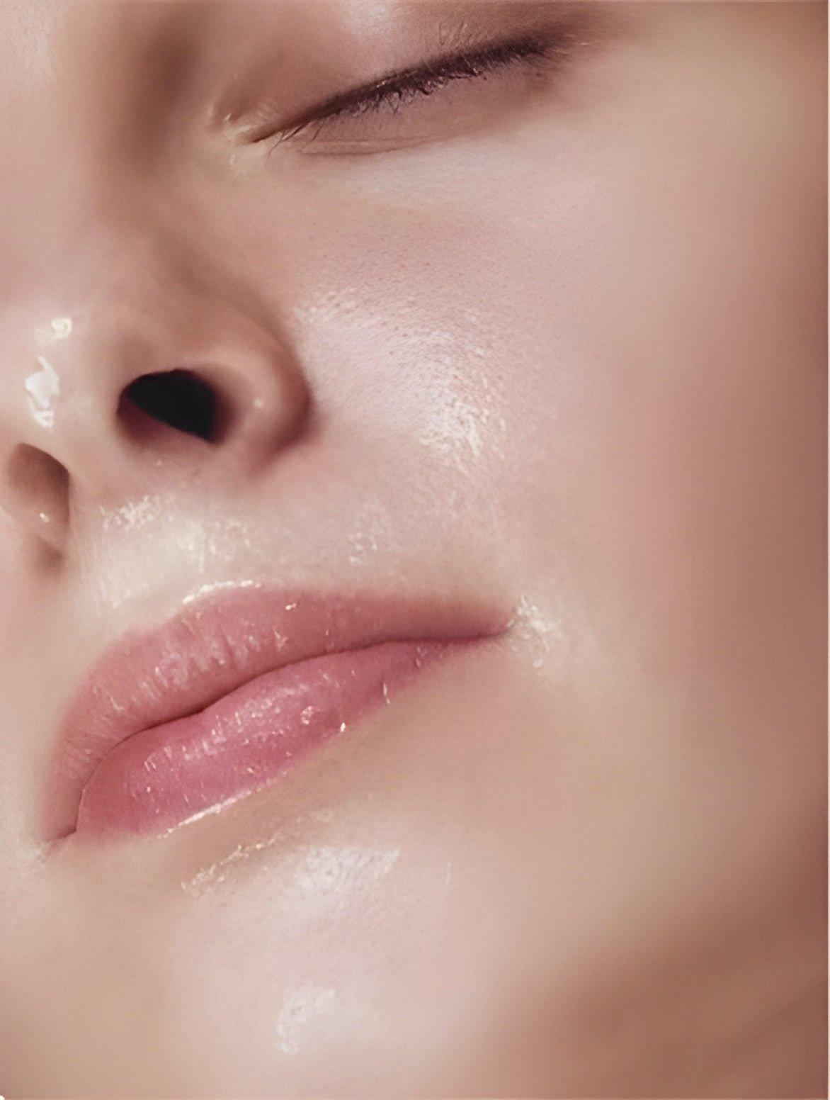 Close-up of a woman using Eclat Soin Glycolic Acid Liquid Exfoliator for radiant skin
