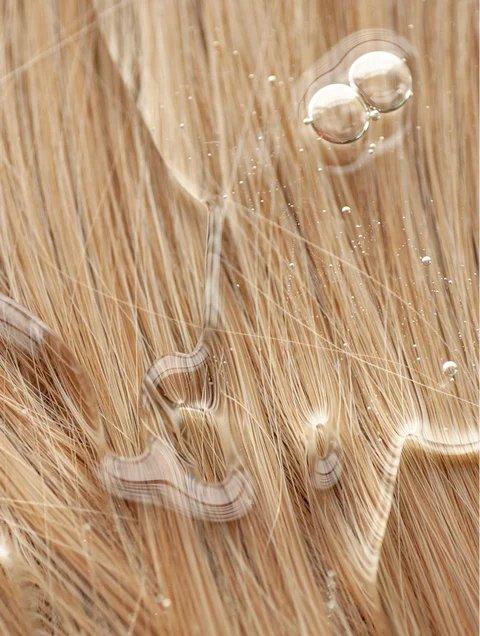 Close-up of silky hair with Nourish and Volumize Shampoo for healthy texture and shine