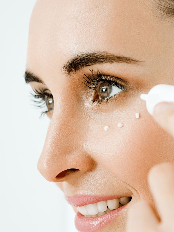 Applying Eclat Soin Puffiness-reducing Brightening Eye Cream to reduce under-eye puffiness