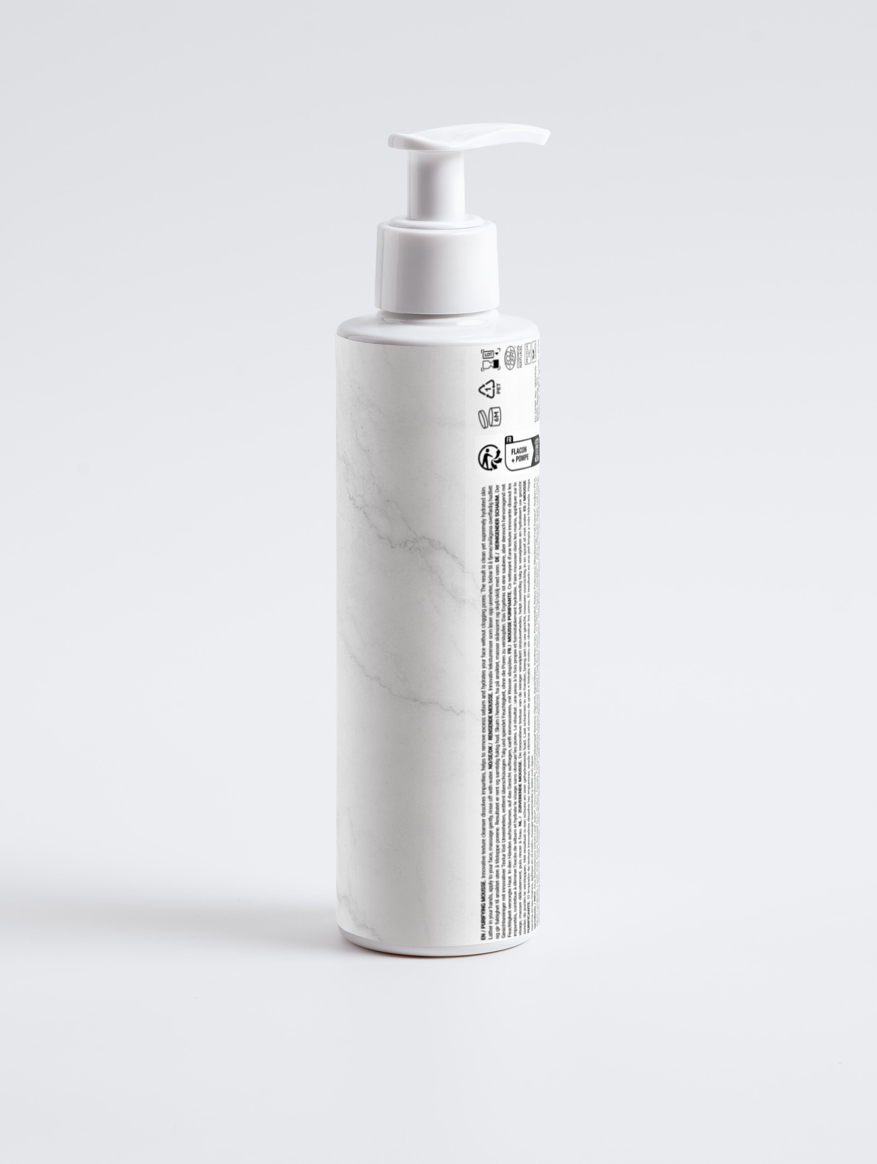 Eclat Soin Purifying Mousse Cleanser in a sleek white pump bottle for gentle skin cleansing