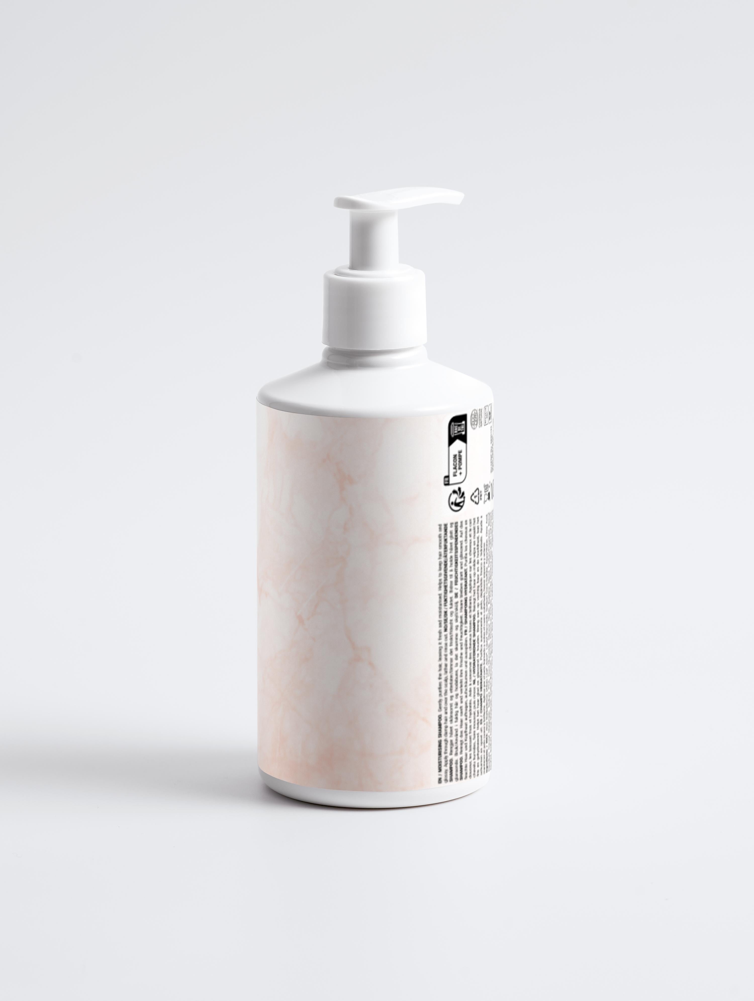 Eclat Soin Moisturising Shampoo bottle with a sleek design and pump dispenser