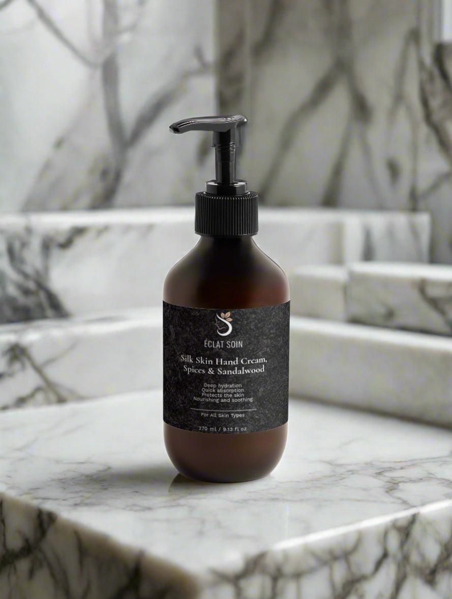 Eclat Soin Silk Skin Hand Cream in a sleek bottle placed on a marble countertop